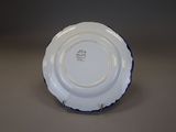 a white plate with a blue rim on a table