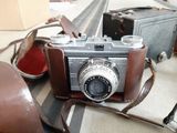 a brown camera and a brown bag on a table