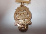 a gold medal with a star of david on it