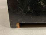 a small black box with a wooden base on a table