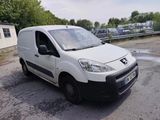 a small white van parked in a parking lot