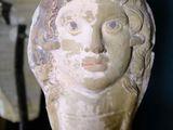 a statue of a woman ' s head on a stand