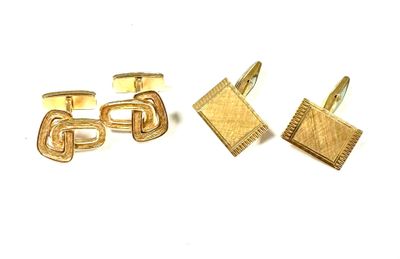 two pairs of gold cufflinks and a pair of cufflinks on a white surface