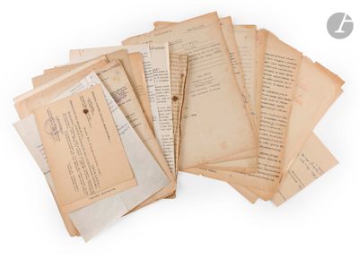 several old papers are stacked on top of each other on a white surface