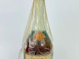 a bottle of wine that is wrapped in a plastic bag