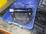 a blue case with a black handle and a white tube