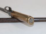 a gun that is laying on top of a piece of metal