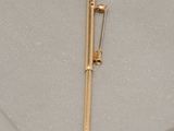 a gold pen and a pair of scissors on a table