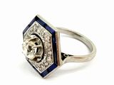 an image of a diamond and sapphire ring on a white background