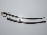 a pair of swords with a gold handle on a white surface