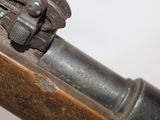 a close up of a rifle with a wooden handle
