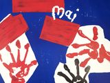 a picture of a child ' s handprints on a blue surface