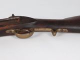 an old rifle with a wooden barrel and brass fittings on it