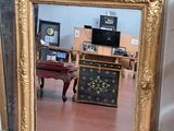 a mirror that is sitting on the floor in a room