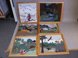 four wooden frames with pictures of people and animals on them