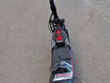 a scooter that is sitting on the ground in the parking lot