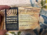 a person holding a ticket for the british carpet centre