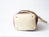 a white and brown bag sitting on top of a white surface