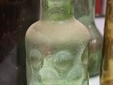 many different colored glass vases sitting on a table