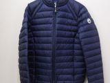 a close up of a blue jacket hanging on a wall