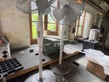 two fans that are sitting on a table in a room