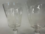 two wine glasses sitting next to each other on a table