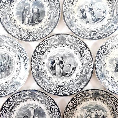 many plates with different designs on them on a table