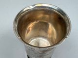 a silver cup that is sitting on a table