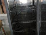 a refrigerator that is open and empty in a room