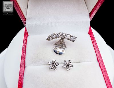 a white box with a pair of earrings in it