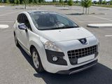 a small white car parked in a parking lot