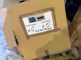 a cardboard box sitting on top of a pallet with a sign on it