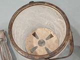 a silver bucket with a handle and a spoon