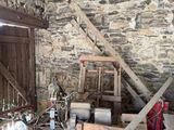 a room with a stone wall and a wooden chair