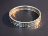 a close up of a silver ring on a table