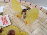 a yellow butterfly sitting on top of a yellow flower