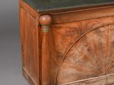 a wooden chest with a leather top on a grey background