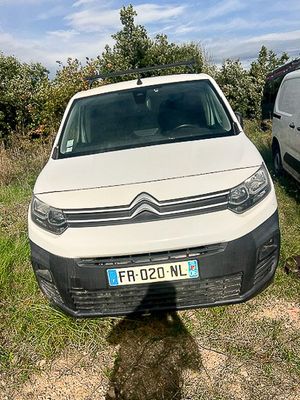 a white van parked next to a white van in a field