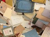 a pile of old letters and envelopes sitting on a table