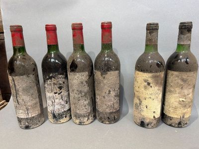 six bottles of wine are lined up in a row on a table
