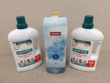 three bottles of saniti and a bottle of soap on a table