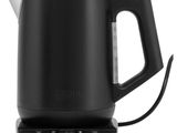 a black electric kettle sitting on top of a white surface