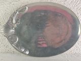 a silver plate with a woman ' s face in it
