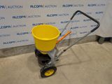 an image of a yellow bucket being pulled by a hand truck