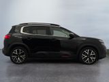 the black suv is parked on the concrete floor in the room