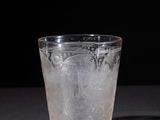 a glass with ice in it sitting on a table