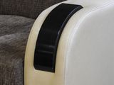 a white couch with a black arm rest on it
