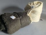 two pieces of wool wrapped in a blanket on a white surface
