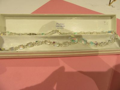 a box that has a bracelet in it on a table