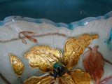 a close up of a decorative bowl with a flower on it